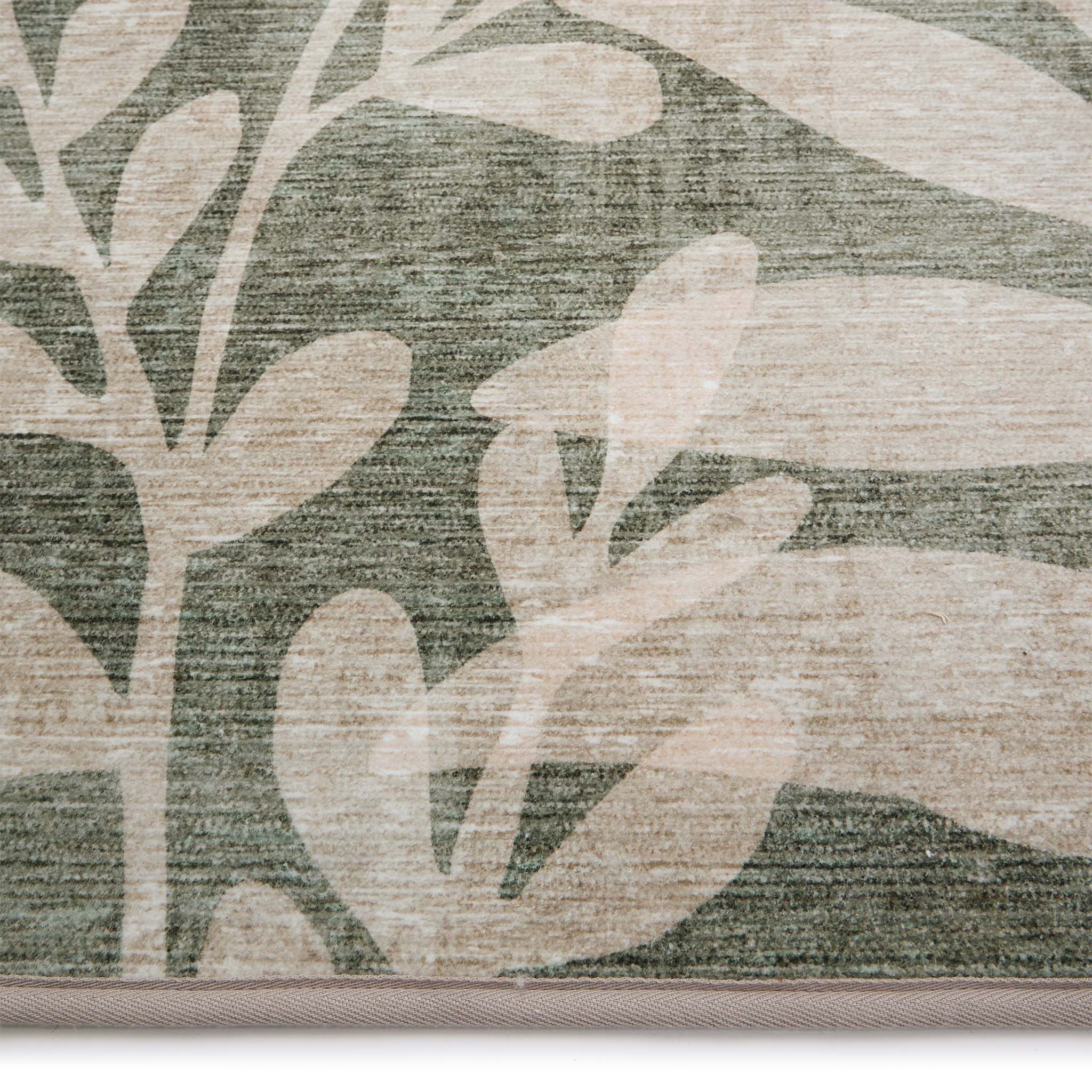 Eden Leaves Green- 100% recycled material rug featuring white florals against a green background.